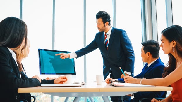 Business people in the conference room with green screen chroma key TV or computer on the office table. Diverse group of businessman and businesswoman in meeting on video conference call . Jivy