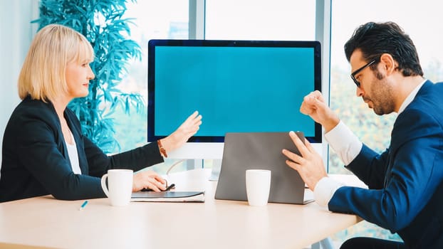 Business people in the conference room with green screen chroma key TV or computer on the office table. Diverse group of businessman and businesswoman in meeting on video conference call . Jivy