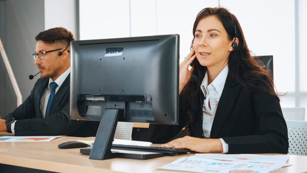 Business people wearing headset working in office to support remote customer or colleague. Call center, telemarketing, customer support agent provide service on telephone video conference call. Jivy