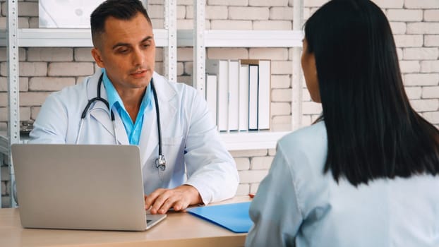 Doctor in professional uniform examining patient at hospital or medical clinic. Health care , medical and doctor staff service concept. Jivy