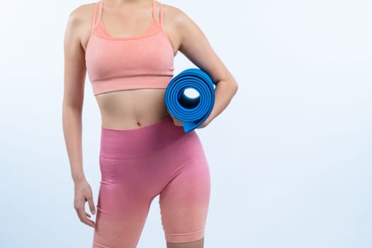 Young attractive asian woman portrait in sportswear with exercising mat. Healthy exercise and workout routine lifestyle concept. Studio shot isolated background. Vigorous