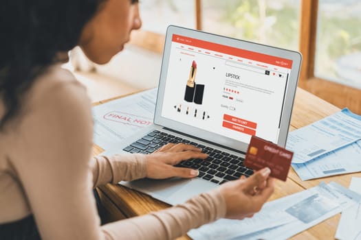 Woman shopping online on internet marketplace browsing for sale items for modern lifestyle and use credit card for online payment from wallet protected by crucial cyber security software