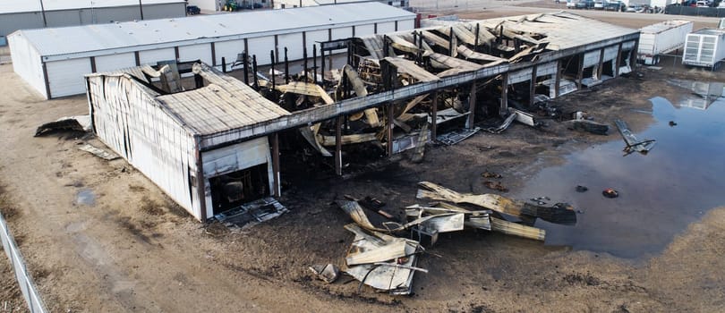 A building has been destroyed by fire. The fire has caused a lot of damage to the building and the surrounding area