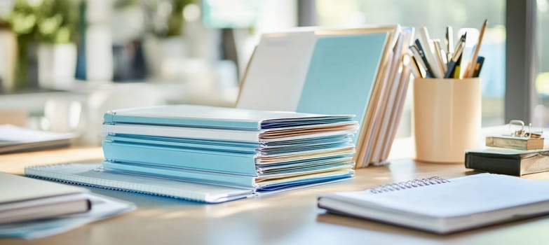 Office desk is filled with folders, notebooks, and writing utensils, suggesting a busy and productive work environment