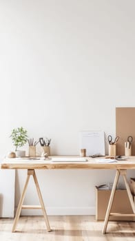 Wooden desk with laptop, stationery, and plant in a minimalist home office setting, promoting productivity and creativity