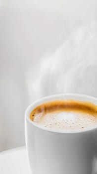 Steaming cup of coffee creating aromatic atmosphere on white background