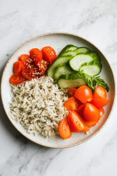 Delicious and nutritious vegan meal featuring rice, cucumber, and cherry tomatoes in a bowl, promoting healthy eating and balanced diets