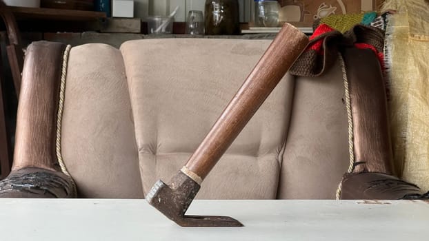 A unique wooden tool is balanced on a table in a workshop, showcasing craftsmanship.