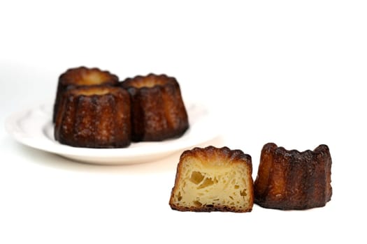 Caneles de bordeaux, traditional French sweet dessert with white table background, High quality photo