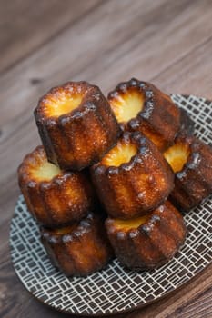 Caneles de bordeaux, traditional French sweet dessert with white table background, High quality photo