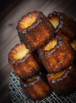 Caneles de bordeaux, traditional French sweet dessert with white table background, High quality photo
