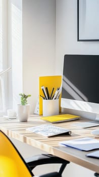 Home office desk with computer, keyboard, mouse, yellow stationery, plant and yellow chair by the window