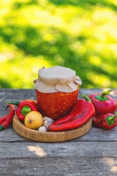 Preserving adjika in a jar. Selective focus. food.