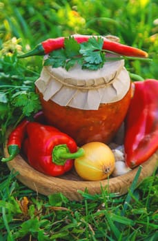 Preserving adjika in a jar. Selective focus. food.