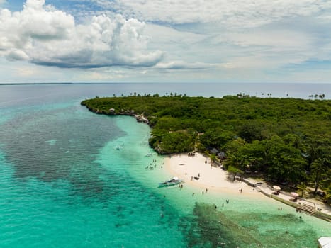 Top view of sandy beach on a tropical island with palm trees. Virgin Island, Philippines.