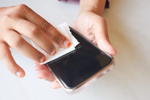 man hand cleaning mobile phone display