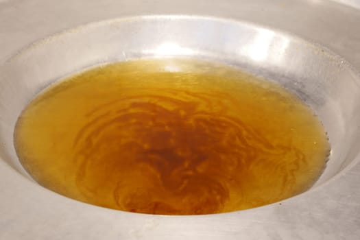 pours vegetable oil into a large frying pan .