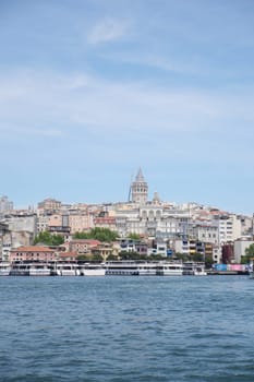 A stunning shot of the iconic Galata Tower overlooking the beautiful water in Istanbul
