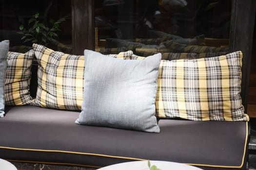 A contemporary outdoor sofa with stylish plaid cushions and a sleek design for any setting