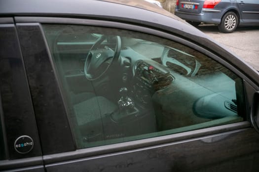 Cremona, Italy - November 15th 2024 Interior view of a parked lancia musa 1.3 multijet ecochic, showcasing its dashboard, steering wheel, and gear stick