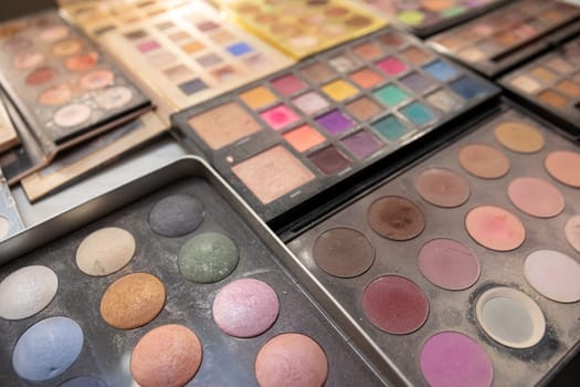 A stunning and vibrant collection of various makeup palettes that brilliantly showcase an array of colors and textures