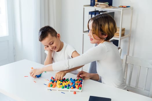 Teacher Playing Educational Games With Boy