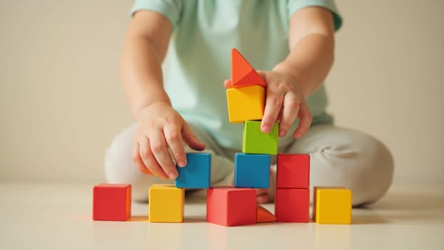 A delighted toddler uses bright, circular stacking blocks to construct a vibrant tower. The playful atmosphere showcases colors of red, orange, blue, and yellow, encouraging imaginative exploration.