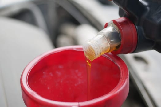 Close-Up of Engine Oil Being Poured During Car Maintenance.