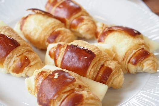Indulge in freshly baked mini croissants that feature a wonderfully crispy, golden exterior