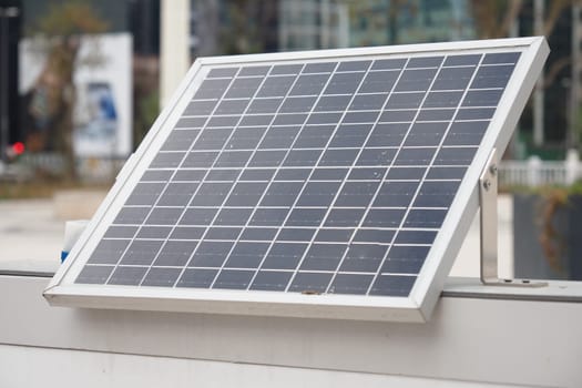 A modern solar panel among skyscrapers, highlighting the use of renewable energy