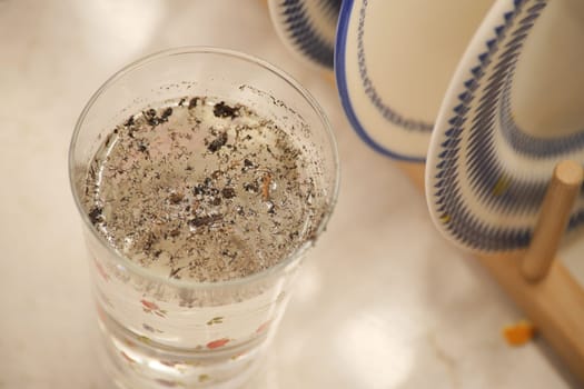 dirty glass of water on kitchen table ,