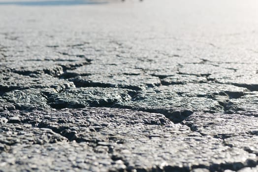 A detailed closeup view of a cracked surface that reflects light in a beautiful manner