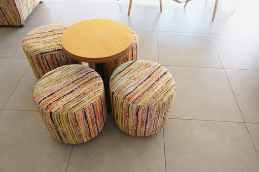 Colorful Round Stools and Table in Modern Interior Setting.