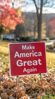 Red and white political yard sign with text reading Make America Great Again