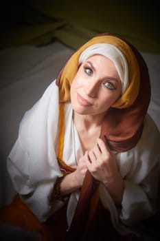 The girl embraces her heritage in stunning traditional attire, personifying Rebekah from the Christian Bible in a peaceful moment.
