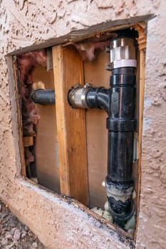 Plumbing Repair Service. Cut Out External Wall of House with Fixed, Replaced Pipe. Repairing Water Supply. No People. Construction. Vertical Plane. Maintenance of Leakage. High quality photo