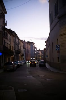 Cremona, Lombardy, Italy - October 27th 2024 Red alfa romeo stelvio veloce 2.0 turbo petrol 280 hp awd automatic, model year 2017, driving on a narrow street at sunset