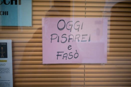 Cremona, Italy - November 27th 2024 Pink sign on a restaurant window in cremona, italy, announcing oggi pisarei e fasò, indicating the availability of this local dish