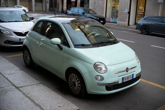 Cremona, Lombardy, Italy - October 27th 2024 A mint green fiat 500 lounge parked on the side of a city street