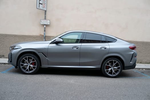 Cremona, Lombardy, Italy - October 27th 2024 Parked bmw x6 m competition in brooklyn grey metallic color, highlighting its sporty and luxurious design