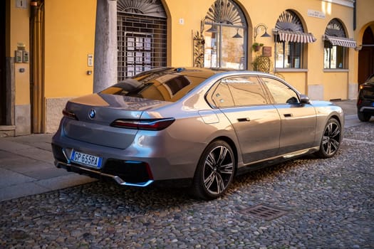 Cremona, Lombardy, Italy - October 27th 2024 Rear view of a luxurious gray bmw i7 electric sedan parked near a traditional european building