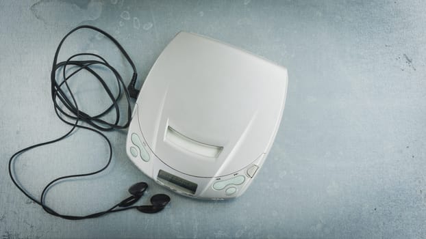 Close up of a vintage portable compact disc player on metal background.