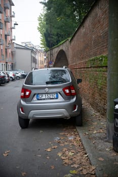Cremona, Lombardy, Italy - October 27th 2024 Metallic grey suzuki ignis 1.2 dualjet hybrid allgrip parked in a narrow street of ferrara, italy