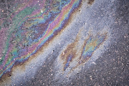 Bright stain from oil or gasoline on asphalt