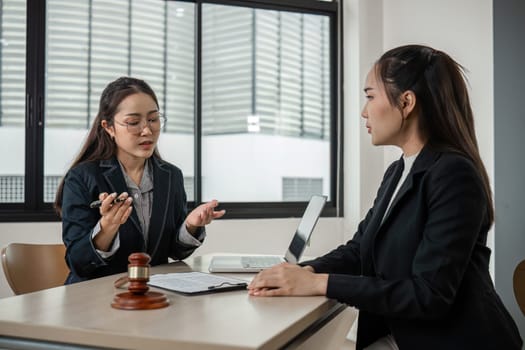 A young lawyer provides expert advice to clients in a contemporary office environment, showcasing professionalism and legal expertise.