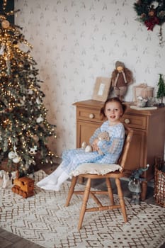 girl 6 years old near christmas tree,