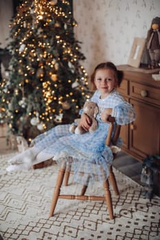girl 6 years old near christmas tree,