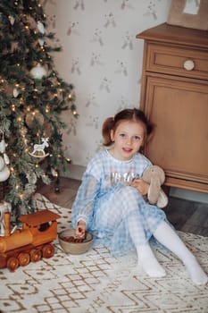 girl 6 years old near christmas tree,