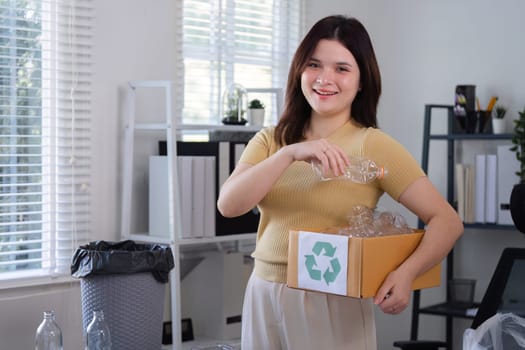 A woman actively recycles plastic bottles at home, promoting environmental sustainability and waste reduction.