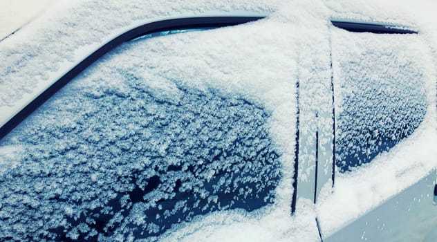 Close up frozen winter car covered snow, view side window on snowy background